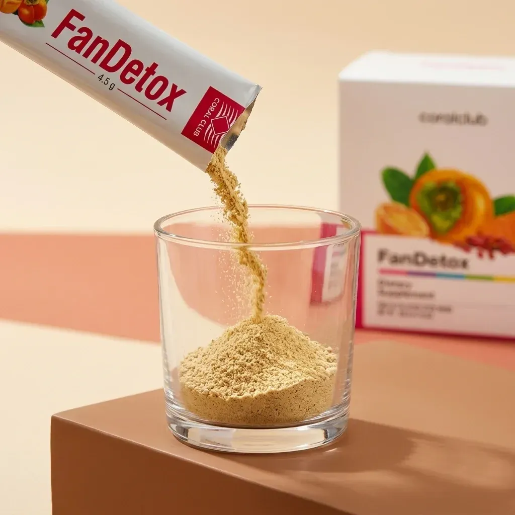 FanDetox powder being poured into a glass, with the product box in the background.