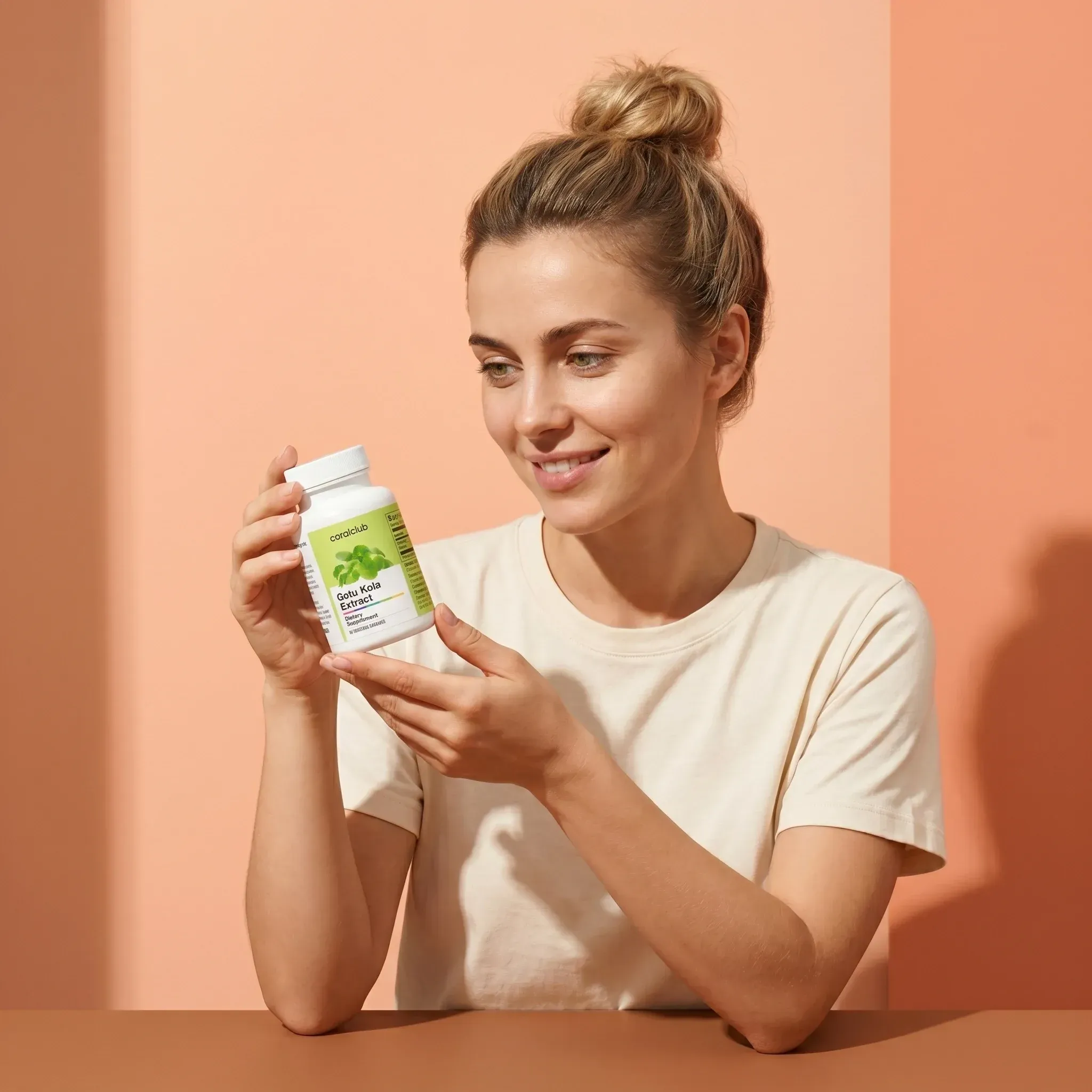 Gotu Kola Extract lifestyle image with a woman holding the supplement bottle against a peach background.