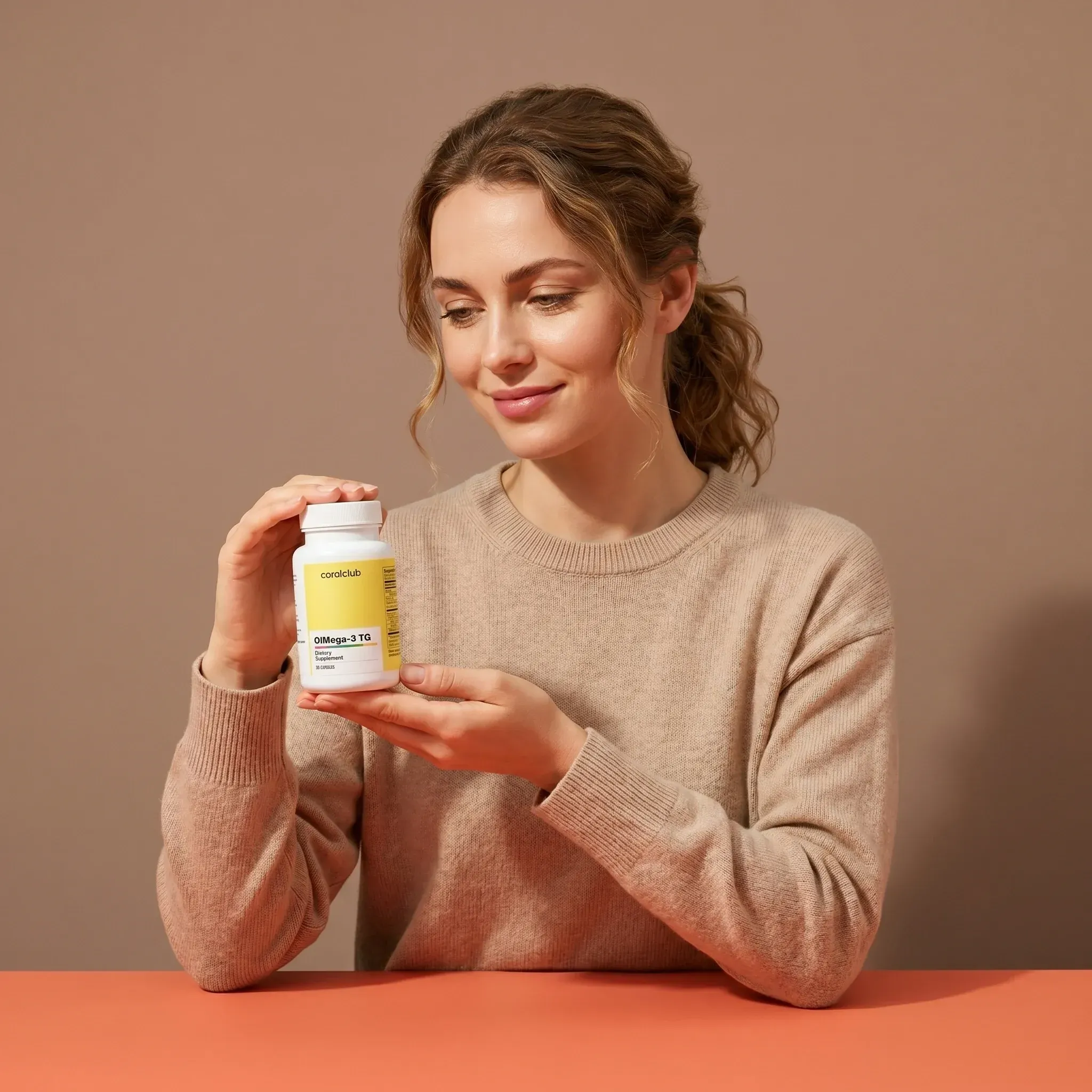 O!Mega-3 TG lifestyle image of a woman holding the supplement bottle against a neutral background.