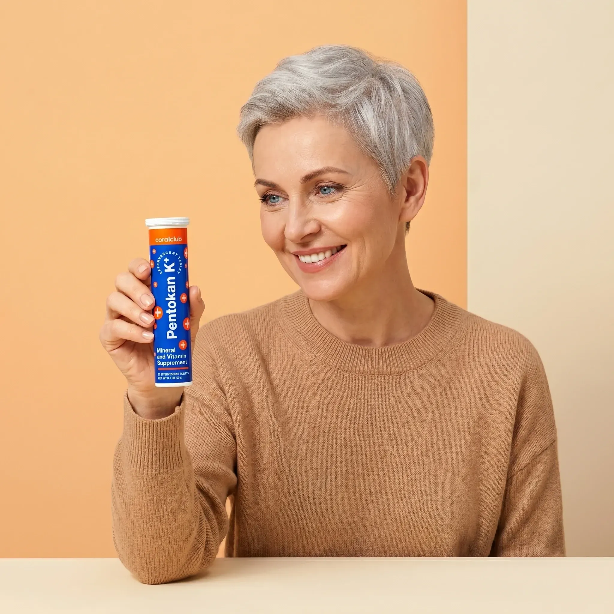 Pentokan K+ lifestyle image of a smiling woman holding the product against a warm background.