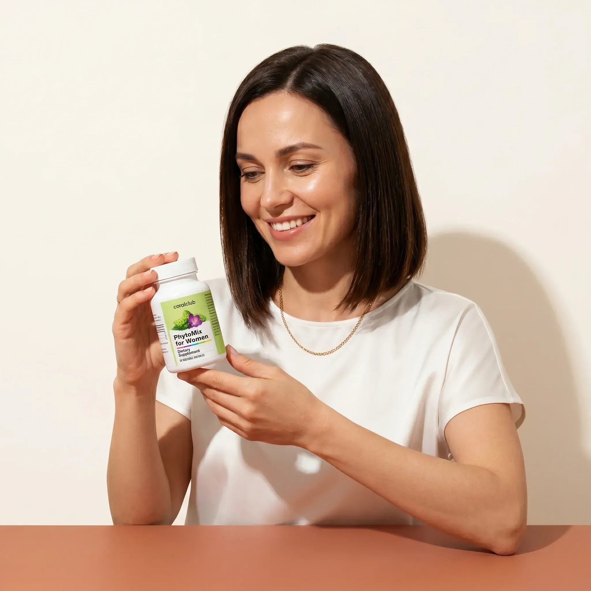 Woman smiling while holding PhytoMix for Women supplement in a lifestyle setting.