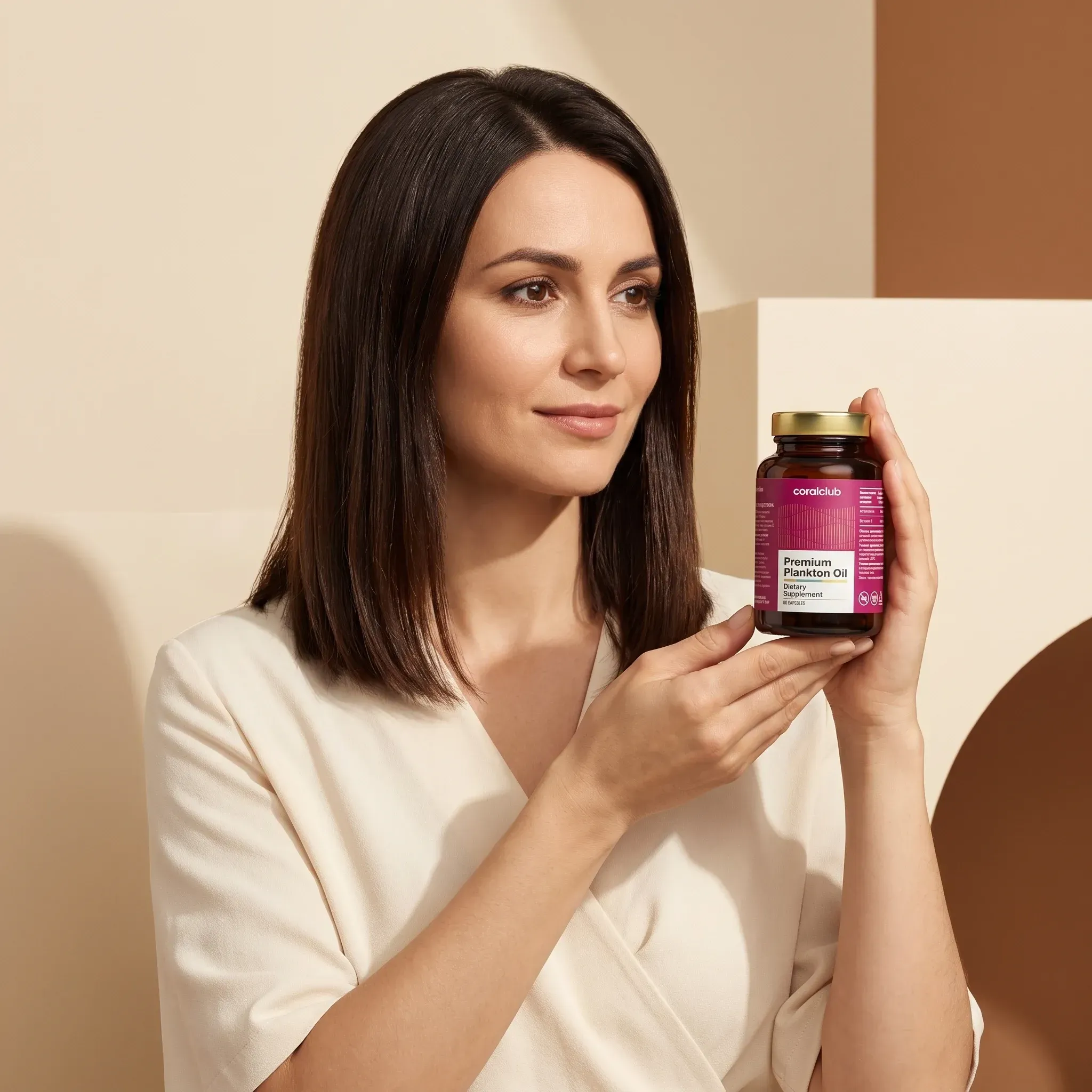 Woman holding Premium Plankton Oil in a lifestyle setting with neutral background.