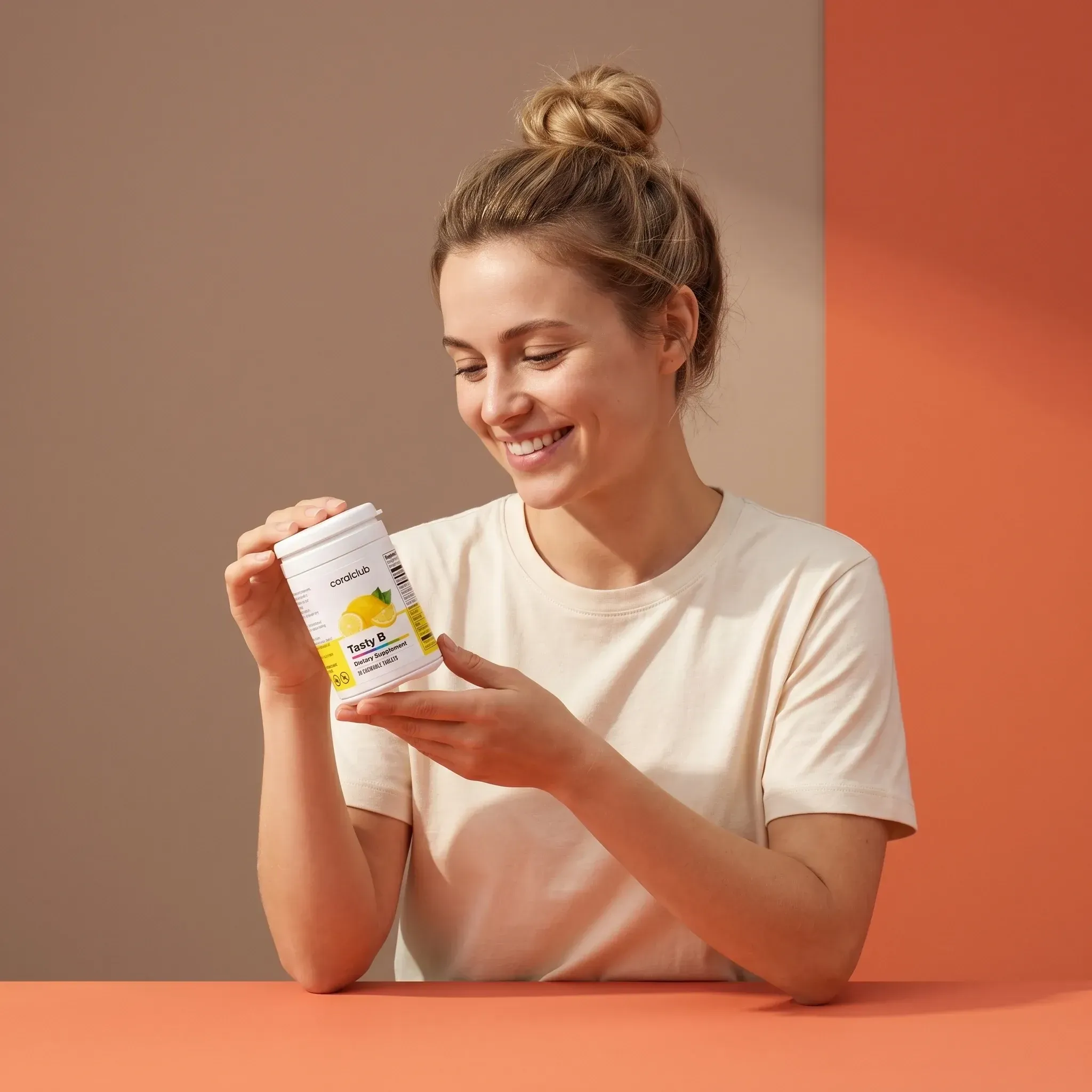Tasty B lifestyle shot with a woman smiling while holding the product container.